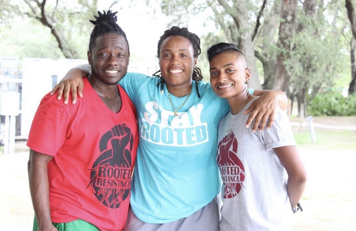Maliq, Roc and Sam smile for a photo after participating in a rootcamp in Tampa, Florida.
